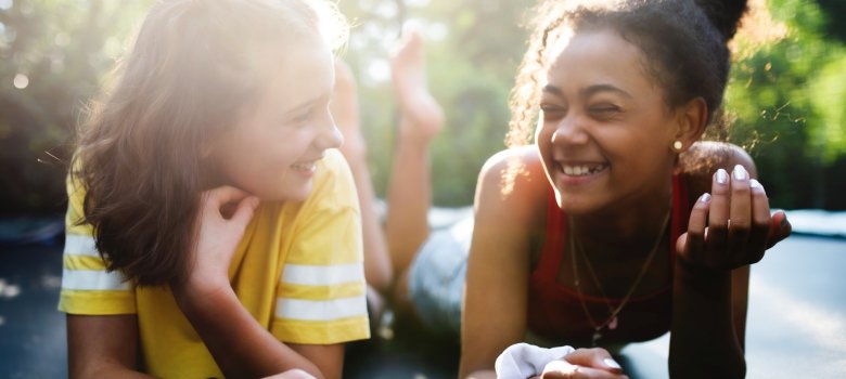 Front view of young teenager girls friends outdoors in garden, laughing. Front view of young teenager girls friends outdoors in garden, laughing.