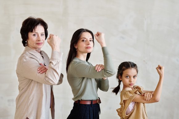 Three females showing their strength