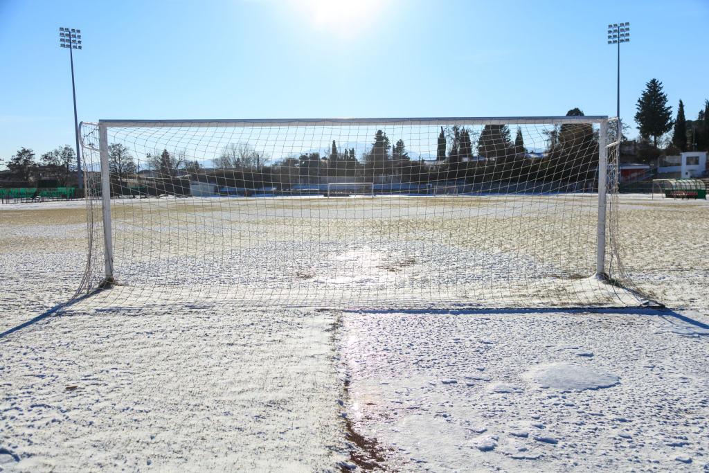 Empty snowy soccerball field