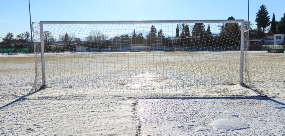 Empty snowy soccerball field