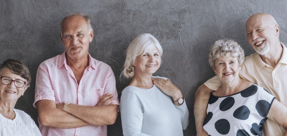 A panorama portrait of a group of happy elderly men and women in