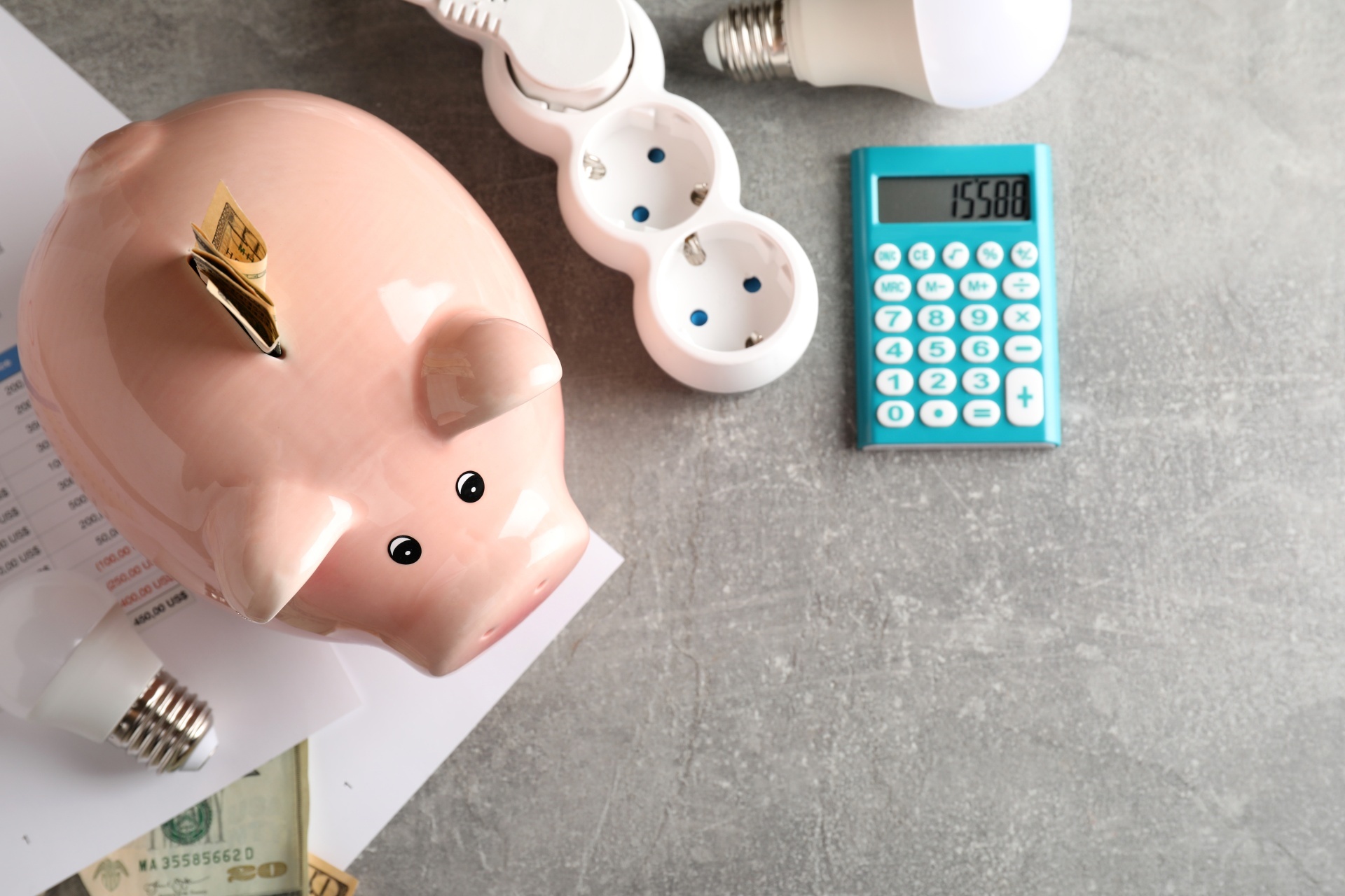 Energy saving concept on gray textured table